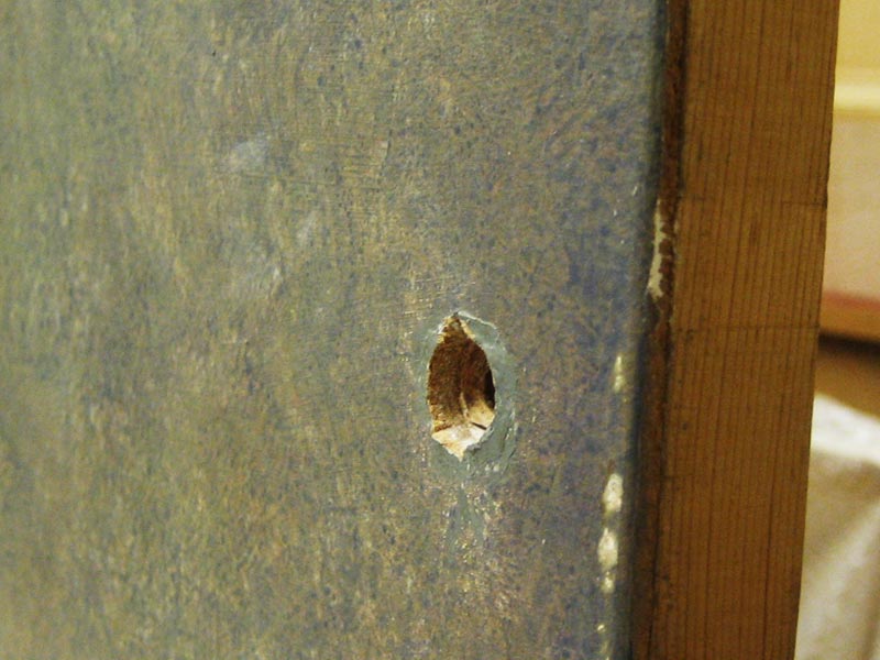 Hole-drilled-through-painting